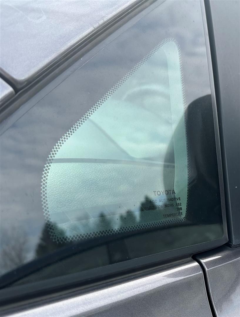 What Are Those Tiny Black Dots on Car Windows?